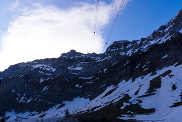 Alpstein mountains with peak S&auml;ntis and cable car cables on a blue cloudy spring morning. Photo taken April 19th, 2022, S&auml;ntis Schw&auml;galp, Switzerland.