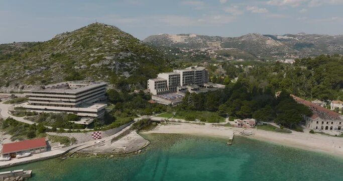 Aerial Pan Across Abandoned Hotel Of Kupari And Beachfront Resorts On Croatia Seaside, 5K Drone