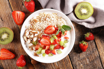 bowl of oat,  yogurt,  fruit and almond