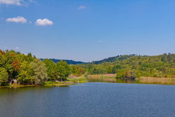 Landscape over calm lake, blue sky