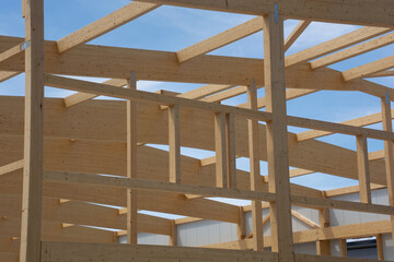 roof and side construction of a large agricultural hangar made of natural wood