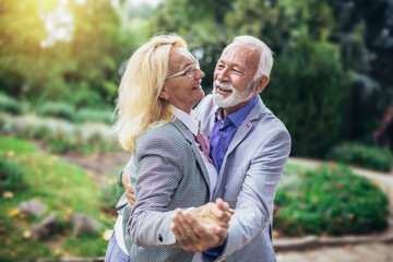Fototapeta premium Cheerful couple dancing at park