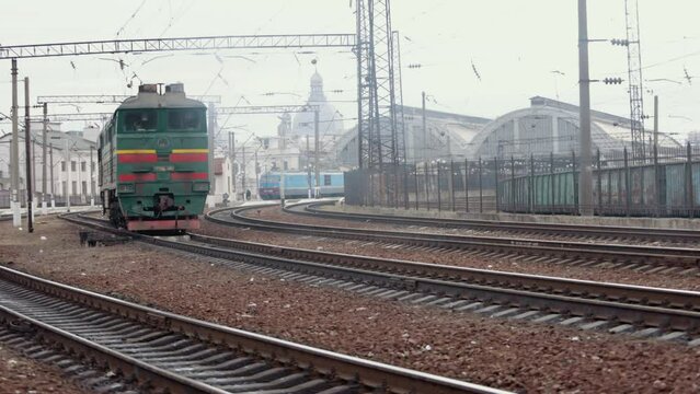Old electric train moving by rail. Outdated design. Soviet electric train traveling. Transportation concept. Old diesel vehicle travels along the railway line. Suburban passenger transportation.