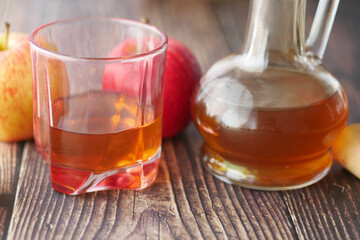 apple vinegar in glass bottle with fresh green apple on table 