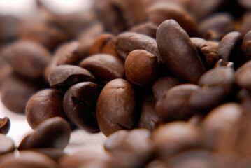 Toasted coffee beans on blured background.