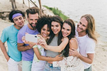 Photo of cheerful best friends take selfie together make memorable shoot video vlog chilling near seaside