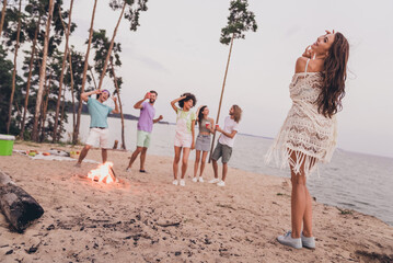 Full size photo of cool carefree people have fun hanging out beach party outside