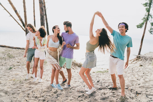 Photo of pretty funky young people wear casual clothes dancing beach party outside countryside