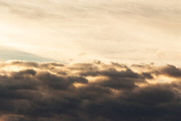 clouds on the sky in golden hour light. warm weather in summer at sunset