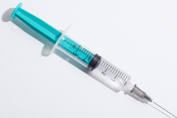 Medical syringe on a white background. A syringe for injection. The concept of health and beauty