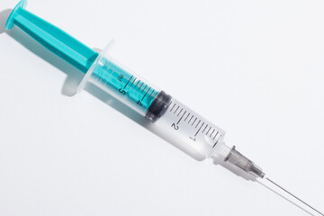 Medical syringe on a white background. A syringe for injection. The concept of health and beauty