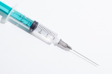 Fototapeta premium Medical syringe on a white background. A syringe for injection. The concept of health and beauty