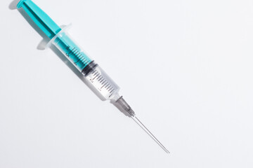 Fototapeta premium Medical syringe on a white background. A syringe for injection. The concept of health and beauty