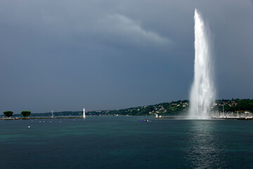 Jet d'Eau - Famous fountain on Lake Geneva - 200 meters high, on right marina in Geneva, on left very popular Paquis beach with white lighthouse, Geneva, Switzerland, Europe