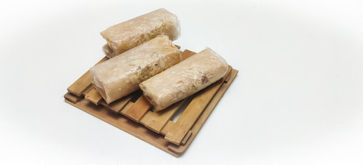 Closeup of South Indian traditional dish or Sweet pootharekelu made with rice floor, ghee and dry fruits. Isolated in a White background with selective focus and copy space for inscription. 