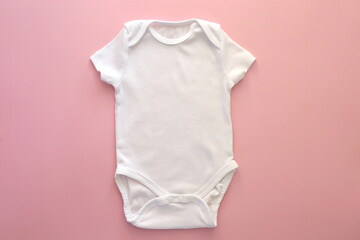 Mockup Flat Lay white bodysuit for on a pink background, for girls. Layout for the design. Baby...