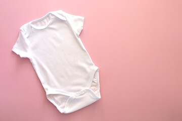 Mockup Flat Lay white bodysuit for on a pink background, for girls. Layout for the design. Baby clothes