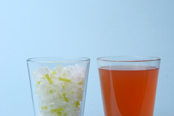 Insulin needles and glass of sweet soda juice drink closeup