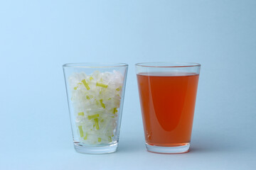 Insulin needles and glass of sweet soda juice drink