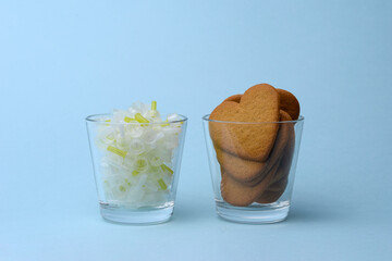 Glass of insulin needles with heart-shaped gingerbread cookies diabetes concept isolated