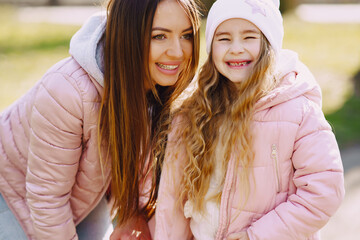 Mother with daughter playing in a spring park