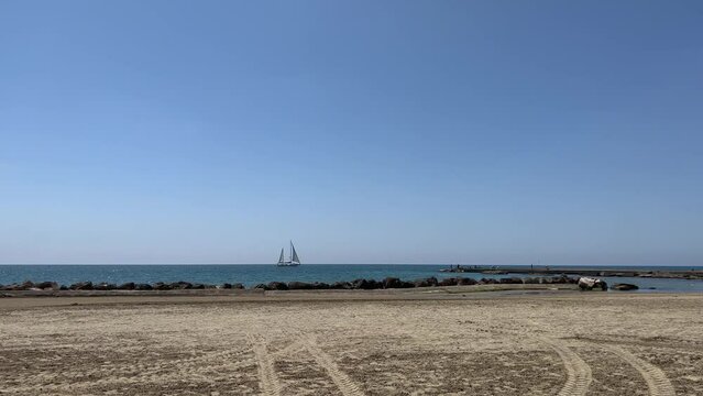 View on sea and yacht from beach in Anzio, Italy