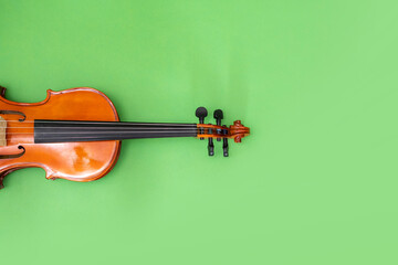 Classical music concert poster with orange color violin on green background with copy space for your text. online music courses. Invitation card with place for text