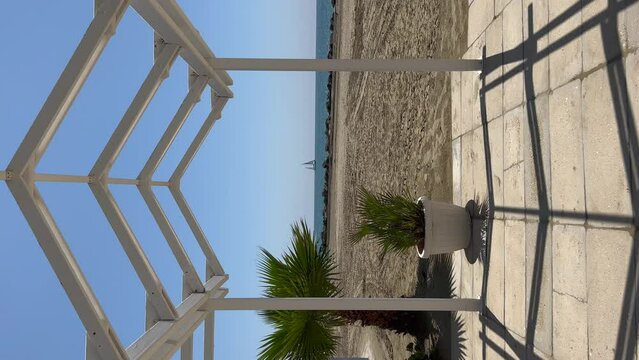 View on sea and yacht from beach in Anzio, Italy. Vertical video