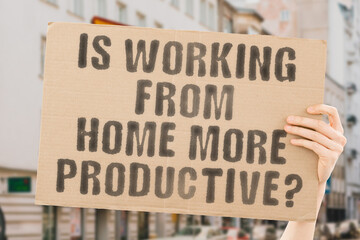 The question " Is working from home more productive?" is on a banner in men's hands with blurred background. Progress. Sofa. Resource. Remote. Energy. Capable. Improved. Increased. Internet. Result