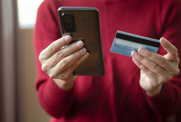 Close up woman hands holding mobile smart phone and credit card, using banking service, online shopping.