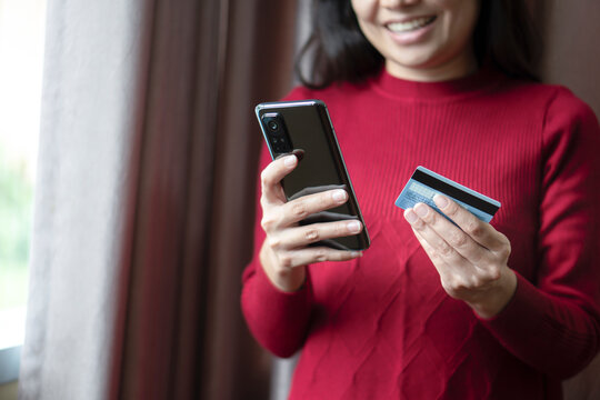 Close up woman hands holding mobile smart phone and credit card, using banking service, online shopping.