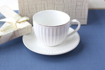 Fototapeta na wymiar Classic white cup and saucer as a gift.