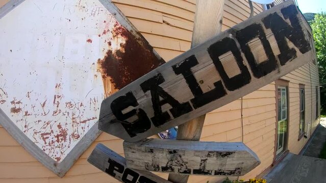 Old Saloon sign made out of wood outside a bar and restaurant in Alberta Canada.