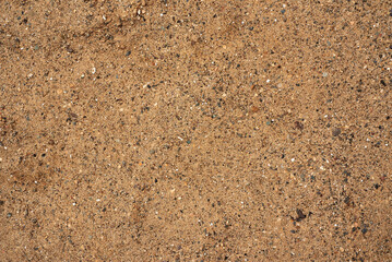 The texture of beautiful coarse sea sand with small pebbles and particles of shells.
