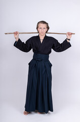 junger Mann in traditionellem Kendo Gewand mit Stock