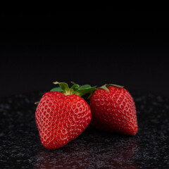 strawberries on marble plate isolated on black background