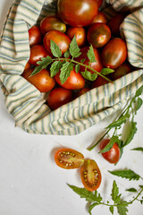 Market delivary of brown tomatoes in eco textile bag, Zero waste, Eco background, Assortment of tomatoes,  local farmers market, Fresh vegetables, harvest .Top view, copy space.