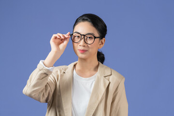 Photo of young girl happy positive smile fix glasses finger look empty space isolated over purple color background