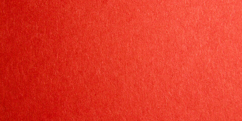 red background with thick paper texture. uneven lighting. Banner for insertion into site. Place for text cope space. Horizontal image.