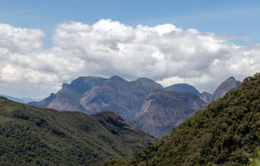 Mountain valley panorama with famous summits from Tres Picos State Park, dense clouds in the background, Teresópolis, Rio de Janeiro, Brazil