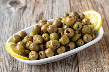 Green olive. natural olive on wood floor background. Healthy food. close up