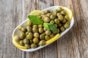 Green olive. Natural boot olive on wood floor background. Healthy food. close up