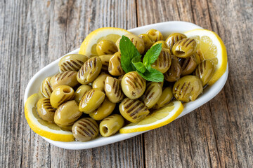Grilled green olives. natural olive on wood floor background. Healthy food. close up