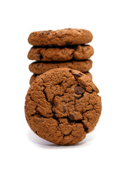 Stacked chocolate oatmeal cookies on a white vertical background. Delicious dessert in the form of homemade oatmeal cookies on an isolated white background. American breakfast with coffee or milk
