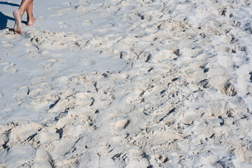 Bottom view of a woman walking barefoot on the tropical beach of Isla Mujeres in Mexico