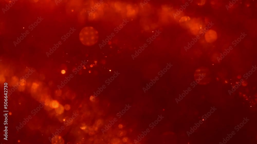 Sticker abstract wavy movement of golden shiny particles in red. dust particles background. shot of real gol