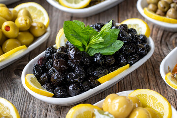 Olives. Varieties of olives on wood background. Healthy food. Selective focus olive. close up