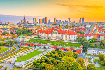 Beautiful panoramic view over the roofs of the Old Town to the Center of Warsaw, the Palace of culture and science, modern skyscrapers and Krakowskie Przedmies. Aerial view. Sunset