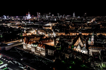 Fototapeta na wymiar Aerial view of old buildings, castles and a church in the old city of Warsaw. Cityscape of old buildings and architecture in the old town in Warsaw. Night time