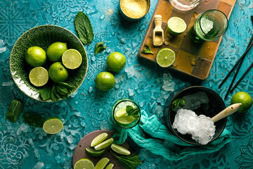 Fresh Mojito cocktail with lime, mint and ice in jar glass on dark blue background